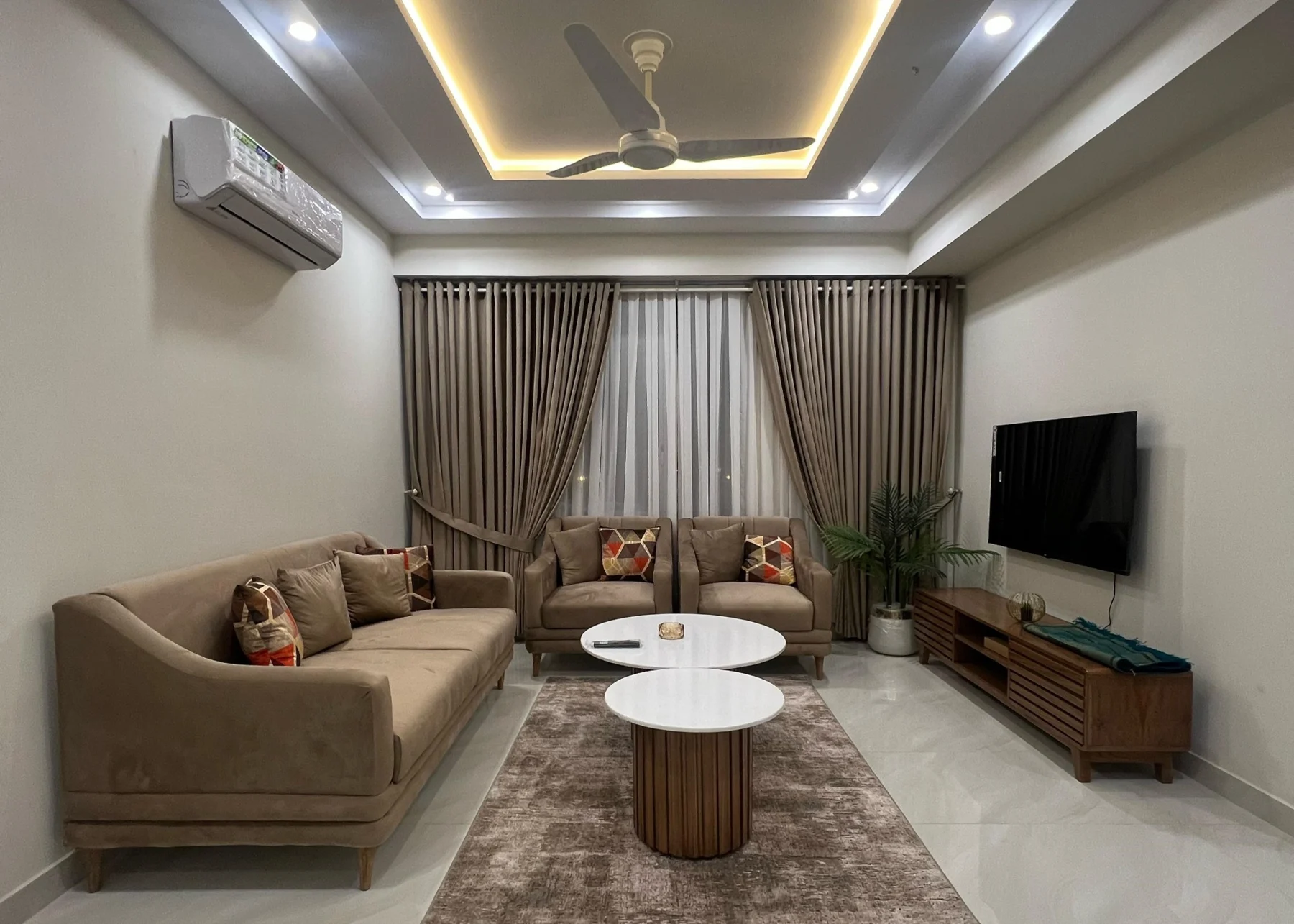Premium Pavilion lounge with beige seating and warm ceiling lighting